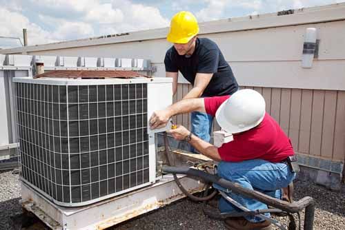 Mechanical contractors work on an HVAC system